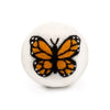 Butterfly-shaped wool dryer ball on a white background