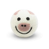 Wool dryer ball with pig face design on a white background